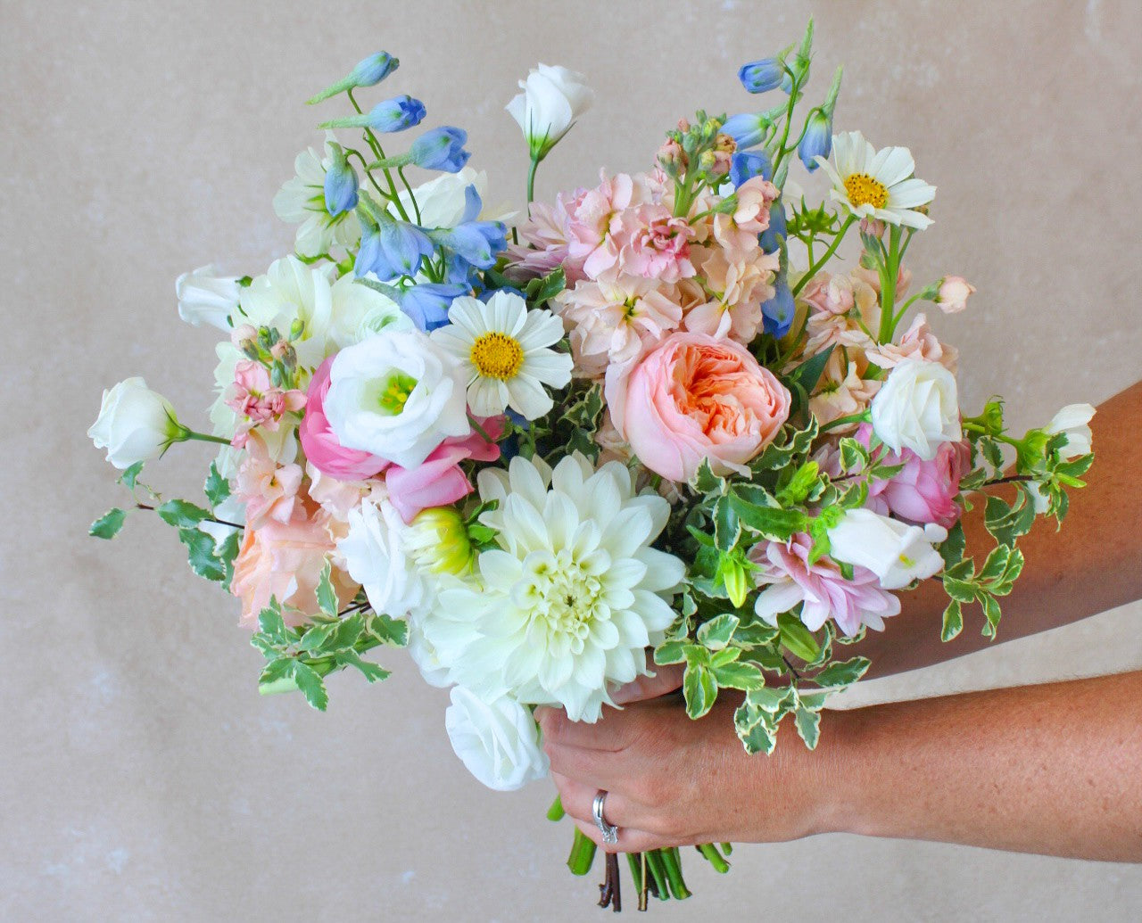 Bouquet of colorful flowers held by a person with bartz vivano