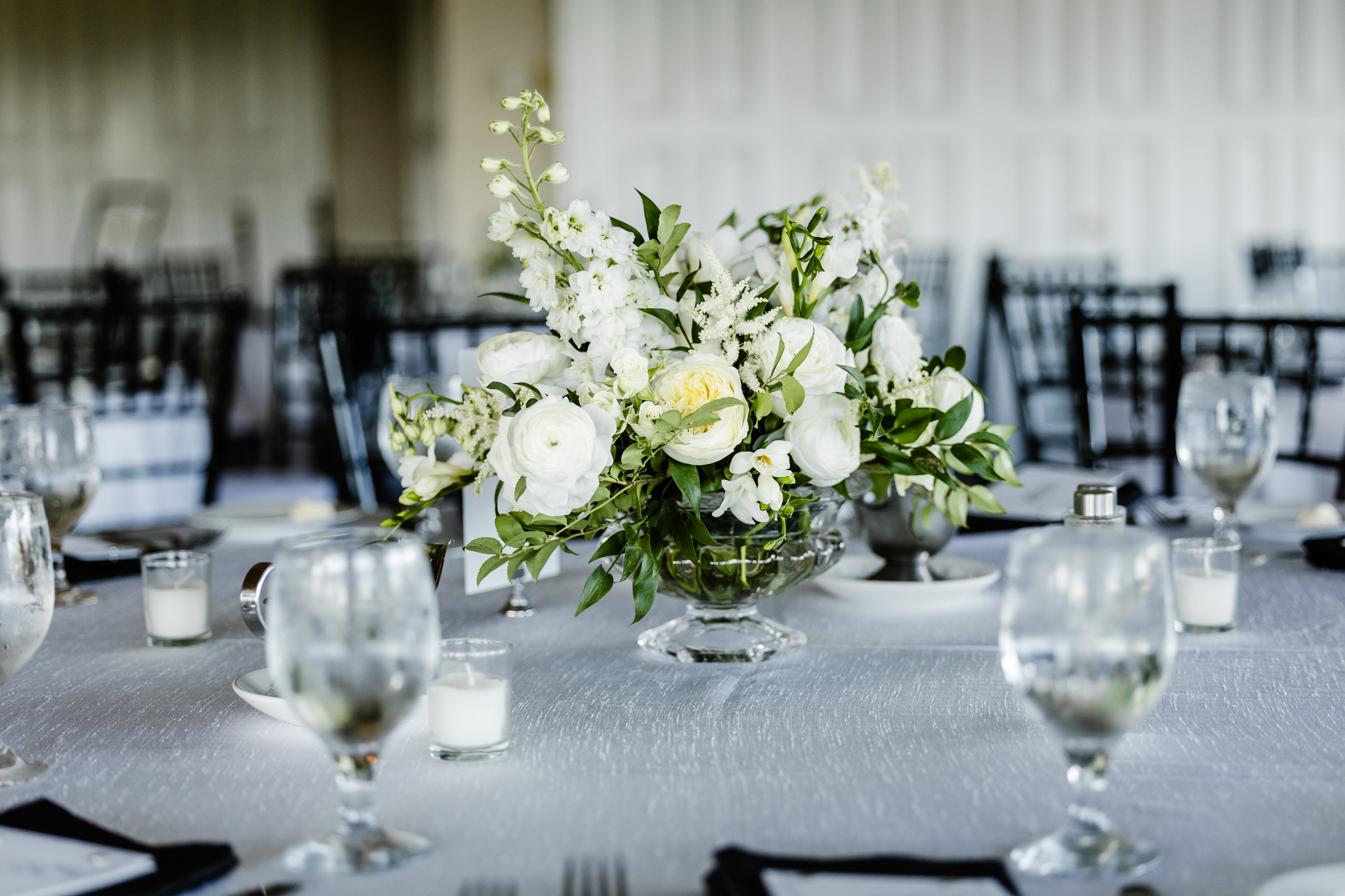 Decorative table setting with flowers and glasses in a formal dining room.