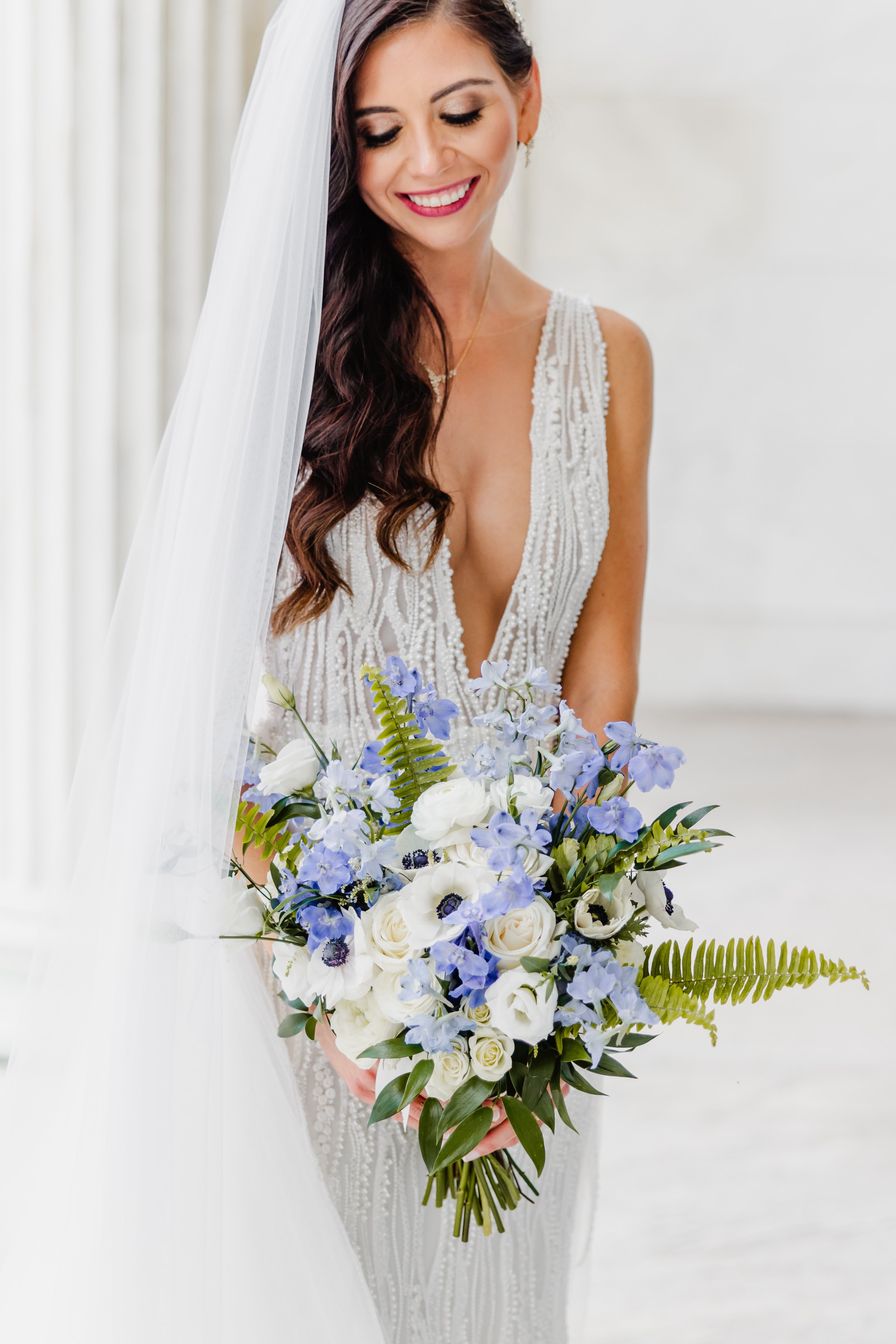 Bride holding a bouquet of flowers with a white background